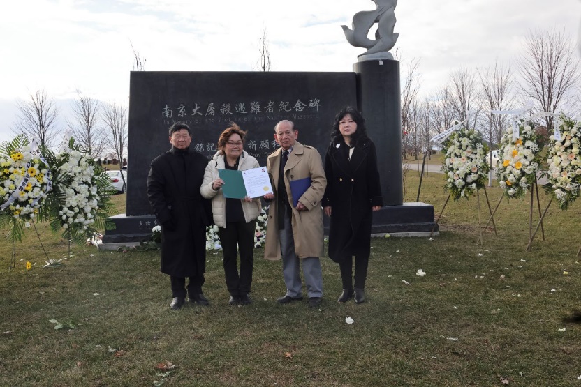 A group of people standing in front of a grave

Description automatically generated