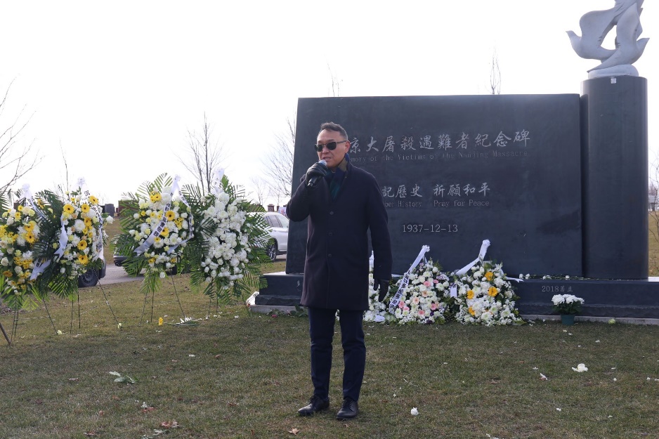 A person standing in front of a grave

Description automatically generated