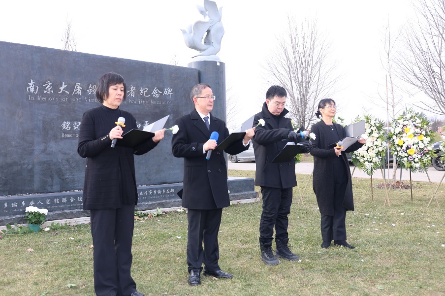 A group of people in black standing in a line holding microphones

Description automatically generated