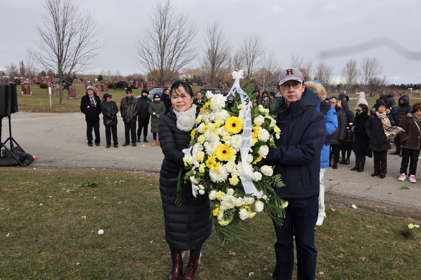 A person and person holding a large bouquet of flowers

Description automatically generated